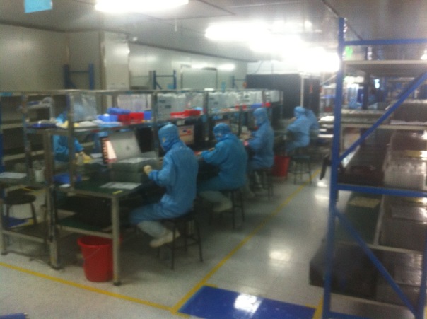 A clean room inspection line.  The photo is taken through a window.